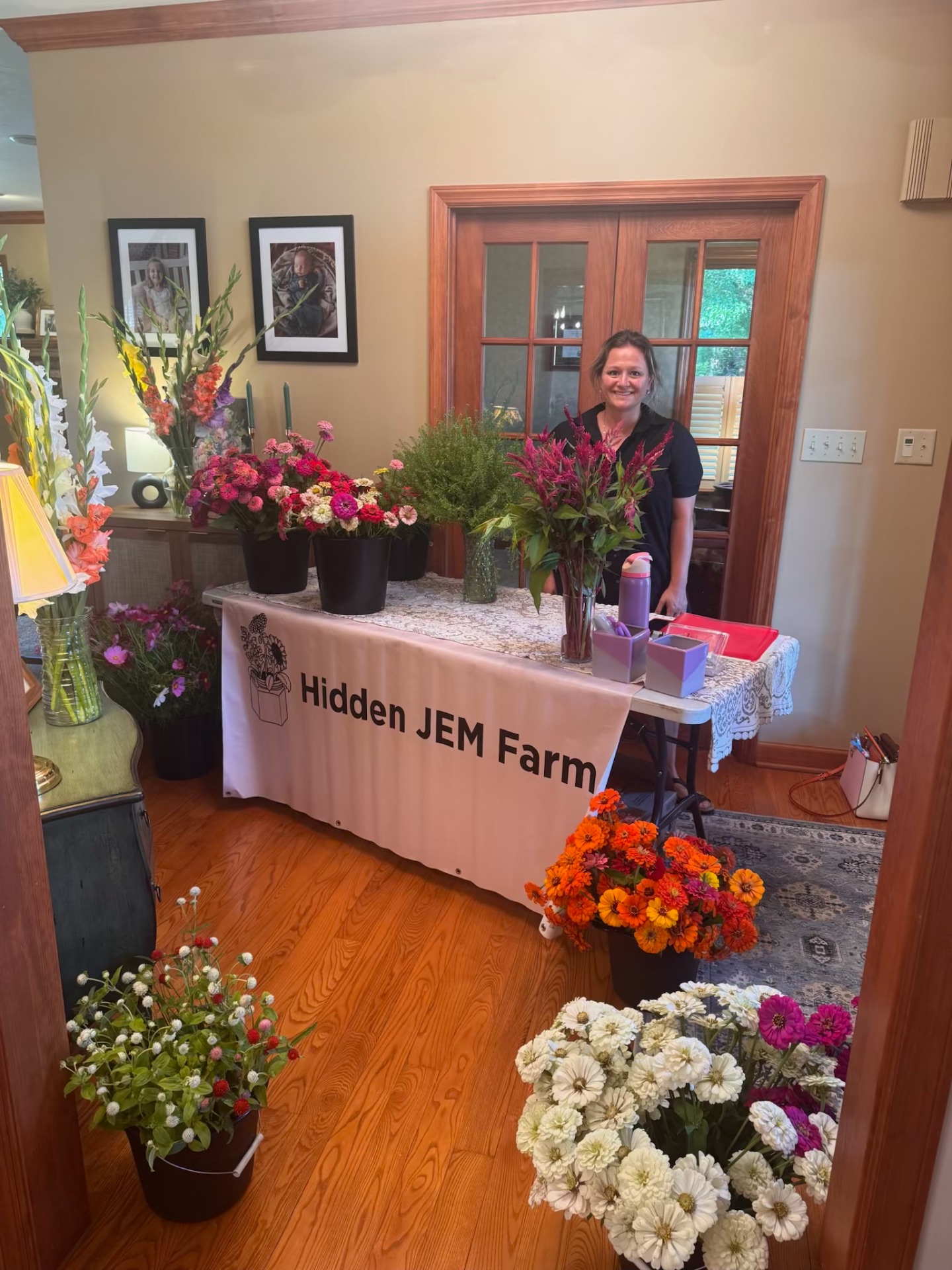 Mollie Repko at the Hidden JEM Farm flower stand with fresh bouquets